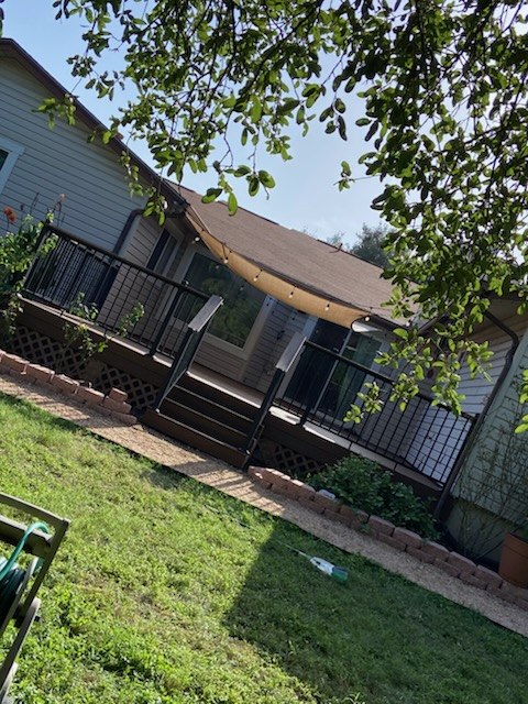 Finished backyard deck with stairs and black metal railing