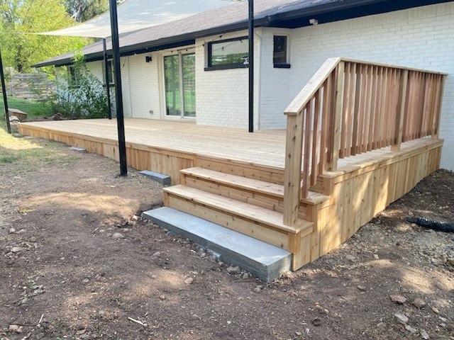 Custom wood deck construction with steps and railing in Austin, TX